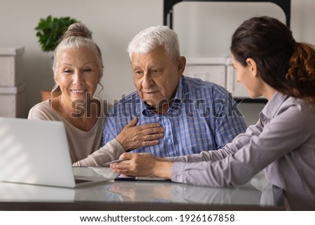 Close up female realtor manager real estate agent consulting mature couple about mortgage or rent, looking at laptop screen, senior family wife and husband listening to financial advisor broker Royalty-Free Stock Photo #1926167858