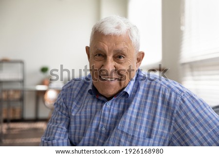 Head shot portrait smiling mature man looking at camera, happy grandfather chatting with relatives online, making video call, senior blogger shooting recording video, elderly teacher working online Royalty-Free Stock Photo #1926168980