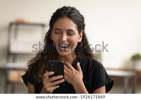 Head shot close up overjoyed surprised woman looking at phone screen, reading good news in message, holding smartphone, smiling female excited great shopping offer, job promotion or money refund