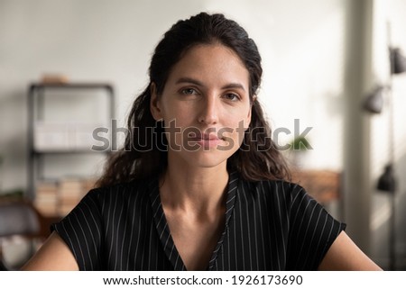 Head shot portrait close up confident woman looking at camera, posing for profile picture, businesswoman making video call to business partner, teacher coach shooting webinar, online course Royalty-Free Stock Photo #1926173690