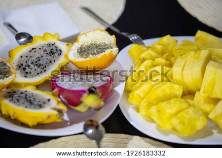 Healthy food. Dragon fruit and granadilla fruit and pineapple on a plate in the cut closeup. Fresh vitamin. Tropical, exotic, fruits background.