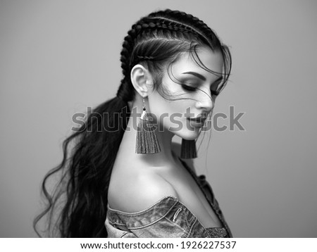 Brunette girl with perfect makeup. Beautiful model woman with curly hairstyle. Care and beauty hair products. Lady with braided hair. Model with jewelry. Black and white photo Royalty-Free Stock Photo #1926227537