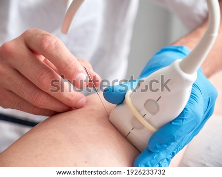 doctor or physio therapist treating a patient with percutaneous elctrolysis Royalty-Free Stock Photo #1926233732