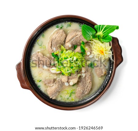 Pork Ribs Soup Korean Food Pork Bone stock white broth decorate vegetables and leek carved style topview