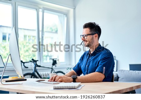 Cheerful consultant working at home  Royalty-Free Stock Photo #1926260837