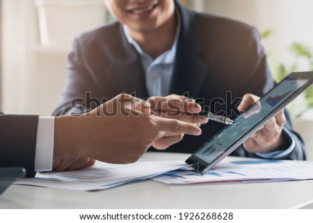financial advisory services. Asian advisor showing plan of investment to clients in the consultancy office. Royalty-Free Stock Photo #1926268628
