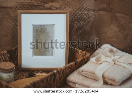 Wooden photo frame in the boho interior, next to the basket