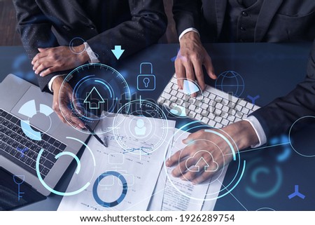 Two research and development specialists man and woman working on project to create a new approach to develop software to improve business. Technological icons over the table with document. Royalty-Free Stock Photo #1926289754