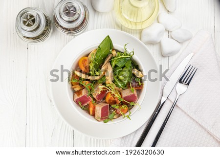 Tuna salad on a white wooden table

