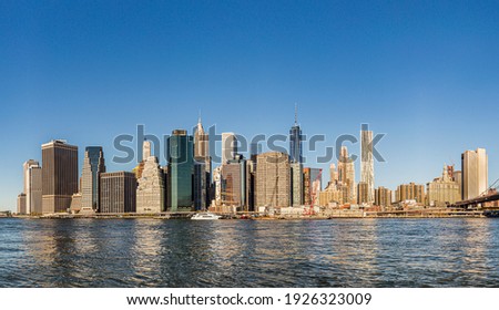 manhattan skyline seen from Brooklyn side on a sunny day