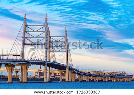 Saint-Petersburg, Russia. The motorway passes over a bridge over the Gulf of Finland. City transport infrastructure. Cable-stayed bridge in Petersburg. Expressway under a beautiful sky. Royalty-Free Stock Photo #1926330389