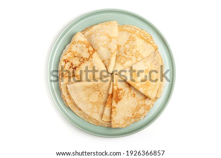 Pancake on the green plate. Many pancakes are stacked. Thin pancakes with crispy crust. Maslenitsa. Pancakes for breakfast and carnival. Food background.