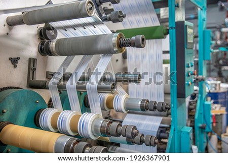 Production of duct tape.Packing tape manufacturing. Strapping Machine for Industrail Packaging Line, Modern machine for packaging line in factory, Industrial and technology concept. Royalty-Free Stock Photo #1926367901