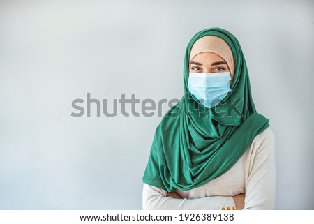 Woman wearing medical mask for prevent dust and infection virus, Coronavirus(covid-19) concept. Pretty Muslim woman wearing hijab and medical mask, preventing the spread of the coronavirus pandemic 