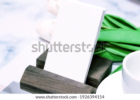 a modern photograph with a business card note on a wooden plate,frame mockup