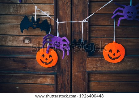 Happy halloween festive garland or banner on vintage wooden background. Holidays, decoration and party concept.