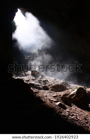 exit from a dark cave, a falling beam of light