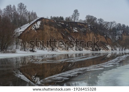picture of a frozen mirror river on the background of a yellow mountain