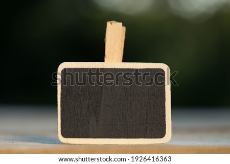 Wooden information label sign with black chalkboard empty place for text on natural background