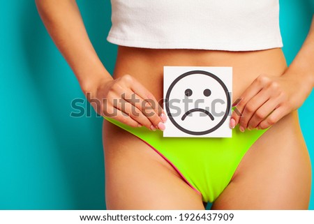 Woman Body Holding Sad Smile Card Near Stomach.