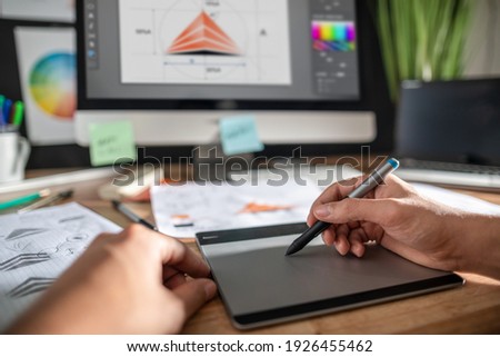 Graphic designer drawing sketches logo design. The concept of a new brand. Professional creative occupation with idea. Royalty-Free Stock Photo #1926455462