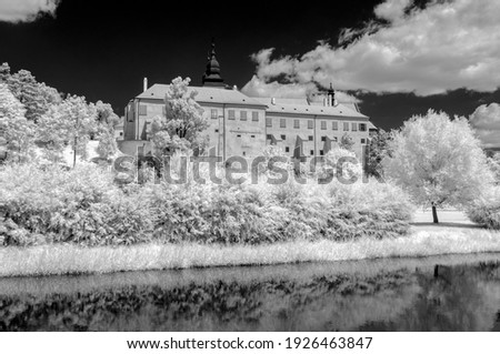 Surrealistic infrared landscape view on Trebic castle made with a modified camera. Czech Republic