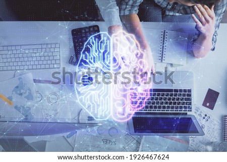 Double exposure of man and woman working together and human brain hologram drawing. Brainstorm concept. Computer background. Top View.