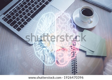 Double exposure of brain drawing hologram over topview work table background with computer. Concept of big data.