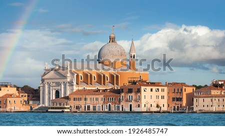 The Church of Santissimo Redentore, or Holy Redeemer, seen from Giudecca Canal, under a rainbow Royalty-Free Stock Photo #1926485747