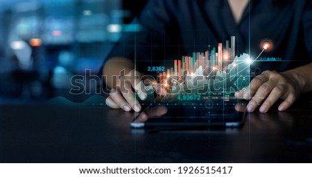 Businessman using tablet analyzing sales data and economic growth graph chart. Business planning and strategy. Analysing trading of exchange. Financial and banking. Technology digital marketing. Royalty-Free Stock Photo #1926515417