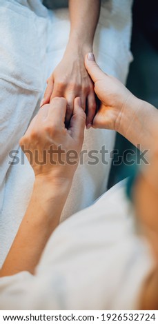 Upper view photo of a finger and palm massage at the spa center