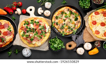 Delicious fresh pizzas variety with different souces and vegetables. Homemade food concept. Top view