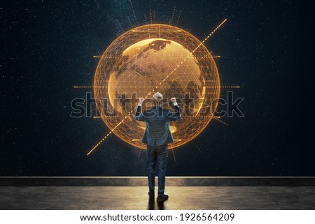 A man in a business suit, a businessman stands against the background of the globe. Mixed media. Concept Global networks and international business. Elements of this image furnished by NASA