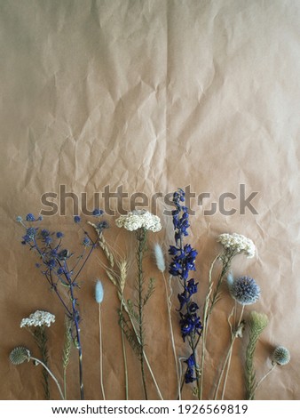 Dried Blue and Cream Flowers on Brown Packaging Paper