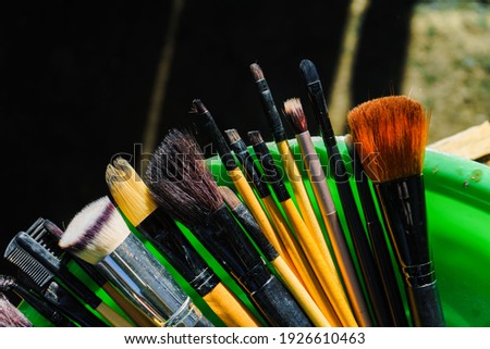A bunch of make-up brushes are dried in the hot sun.