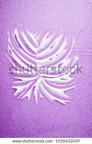 Drawing painted on textured strokes of white cream for skin care and moisturizing, on a shiny pink background. 