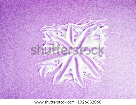 Drawing painted on textured strokes of white cream for skin care and moisturizing, on a shiny pink background. 