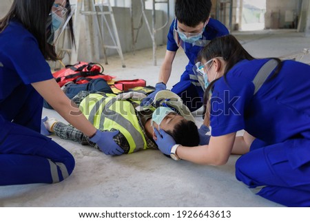 First aid for head injuries and Considered for all trauma incidents of worker in work, Loss of feeling or loss of normal movement and Loss of function in limbs, First aid training to transfer patient. Royalty-Free Stock Photo #1926643613