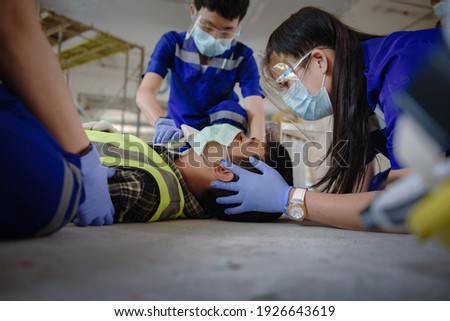 First aid for head injuries and Considered for all trauma incidents of worker in work, Loss of feeling or loss of normal movement and Loss of function in limbs, First aid training to transfer patient. Royalty-Free Stock Photo #1926643619