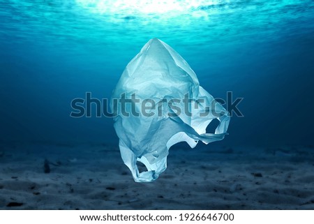 Plastic bag in the ocean Royalty-Free Stock Photo #1926646700