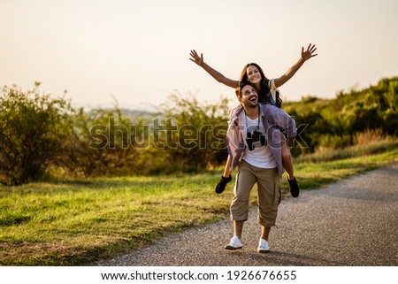 Happy couple is hiking in mountain. They are having fun in nature. Royalty-Free Stock Photo #1926676655