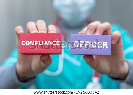 Medical concept of compliance officer. Doctor or nurse hold in hands polystyrene foam block with compliance officer words. Royalty-Free Stock Photo #1926680342