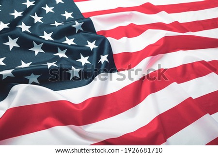Close up of ruffled American flag. Satin texture curved flag of USA. Memorial Day or 4th of July. Banner, freedom concept