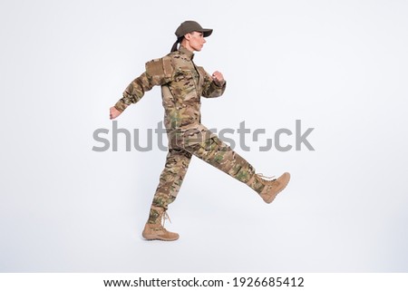 Full length profile photo of focused young person look empty space marching isolated on white color background