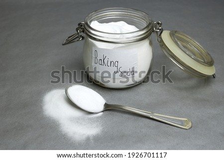 Baking soda isolated on gray background Royalty-Free Stock Photo #1926701117