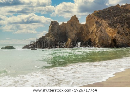 Pfeiffer Beach, in Big Sur is an incredibly picturesque beach, beautiful landscape on the Pacific coast, rocks, sand, ocean and sky. Concept, vacation, photo for postcards, tourist and travel guide.