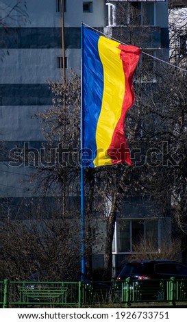 The flag of Romania flutters in the wind. National Day of Romania
