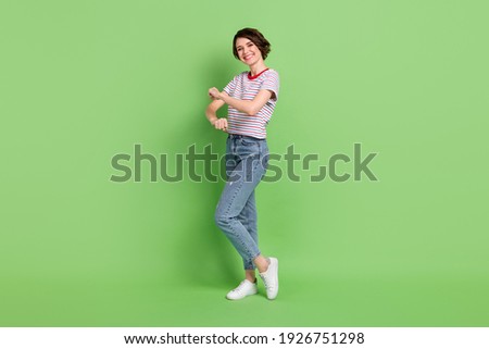 Full length body size view of attractive cheerful childish girl dancing having fun rest isolated over green pastel color background