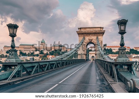 Empty Chain bridge on Danube river at sunrise in Budapest, Hungary Royalty-Free Stock Photo #1926765425