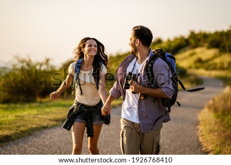 Happy couple is hiking in mountain. Royalty-Free Stock Photo #1926768410